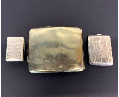 A hallmarked silver match book cover together with a hallmarked silver match box cover and a silver-plated cigarette case.