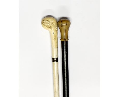 An antique carved whale bone sectional walking stick, L. 83cm, together with a horn handled walking stick.