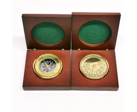 A cased compass and world timer.
