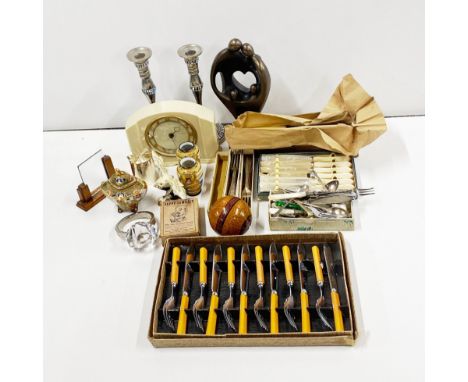 A cream bakelite mantle clock and other items.