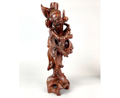A Chinese carved hardwood figure of a fisherman, H. 38cm. Previously mounted as a table lamp base and some age cracking.