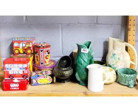 A group of collectable tins and ceramic items.