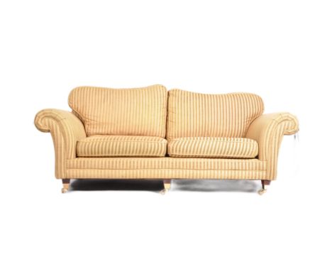 Kirkdale - A large contemporary designer two seat sofa settee&nbsp;upholstered in striped green and yellow fabric raised on t