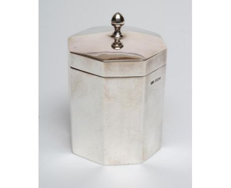 A SILVER CANISTER, maker Walker &amp; Hall, Sheffield 1917, of plain octagonal form, the hinged cover with faceted knop, 4" h
