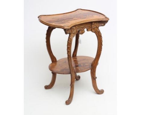 A CARVED BEECH AND MARQUETRY OCCASIONAL TABLE in the style of Louis Majorelle, the waisted oblong top inlaid with flowers, on