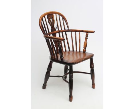 A YEW WINDSOR ARMCHAIR, 19th century, of low hooped back form with shaped and pierced splat, baluster turned arm supports, el