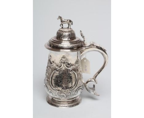 AN EARLY GEORGE III SILVER TANKARD, maker's mark I &amp; M, London 1768, of baluster form, the hinged high domed cover with o