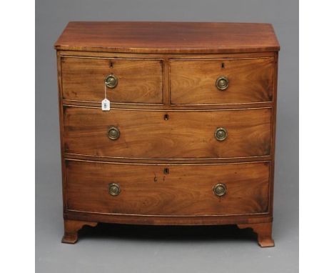 A REGENCY MAHOGANY SMALL BOWED CHEST, the caddy top over two short and two long drawers with later brass ring handles, on bra