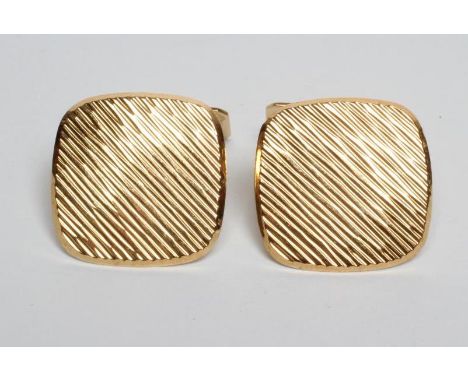 A PAIR OF MODERN CUFFLINKS of rounded square section with brushed bark effect finish and engine turned oblong swivel plaques,