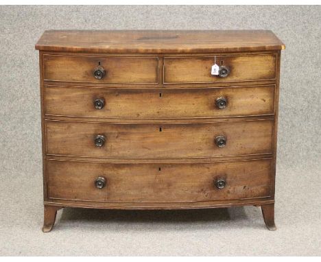 A REGENCY MAHOGANY BOWED CHEST, early 19th century, the moulded edged top over two short and three long cockbeaded drawers wi