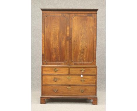 A GEORGIAN MAHOGANY LINEN PRESS, third quarter of 18th century, the dentil moulded cornice over frieze with veneer banding, a