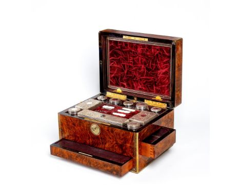 A MID VICTORIAN BURR WALNUT TRAVELLING DRESSING CASE WITH SILVER FITTINGS by Parkins &amp; Gotto, London, strung with brass a