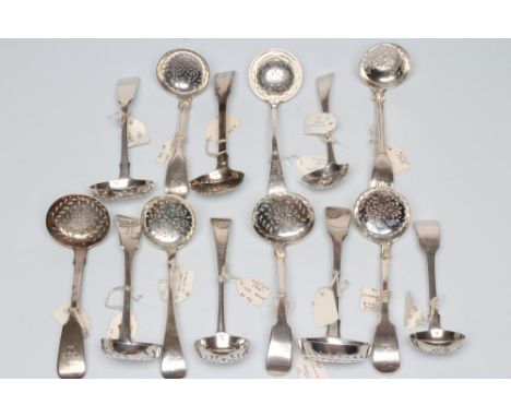 A COLLECTION OF GEORGE III AND LATER SILVER SUGAR SIFTER SPOONS, all with flower pierced bowls including a double struck fidd