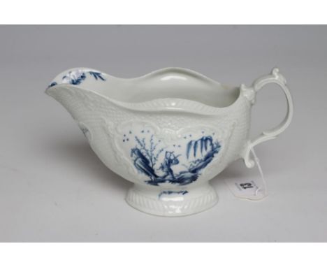 A FIRST PERIOD WORCESTER PORCELAIN SAUCEBOAT, c.1765, of lobed oval form with scroll moulded panels on a basket weave ground,