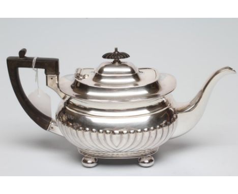 AN EDWARDIAN SILVER TEAPOT, maker's mark CB &amp; S, Sheffield 1906, of semi fluted oblong baluster form with swept shoulders