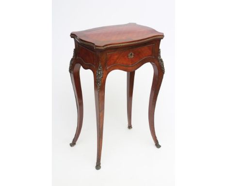 A LOUIS XV STYLE WORK TABLE, 19th century, in kingwood and tulip wood with gilt metal mounts, shaped oblong top with parquetr