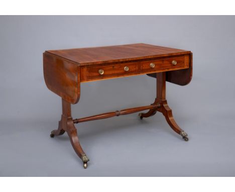 A REGENCY MAHOGANY AND ROSEWOOD BANDED SOFA TABLE, of rounded oblong form with ebony stringing, the banded top over two true 