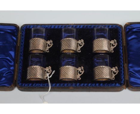 A SET OF SIX LATE VICTORIAN SILVER TOT HOLDERS, maker's mark LE., Birmingham 1893, of wrythen fluted cylindrical form with ca