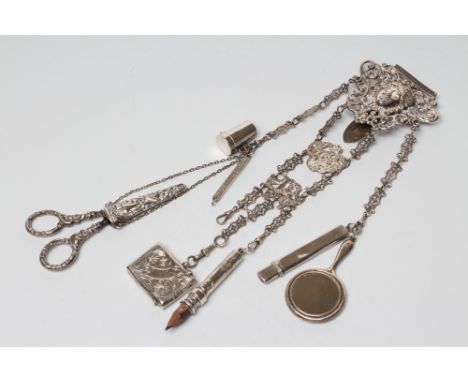 A LATE VICTORIAN SILVER CHATELAINE, maker Charles Boyton, London 1889, the cast open scroll belt clip centred by a mask and h