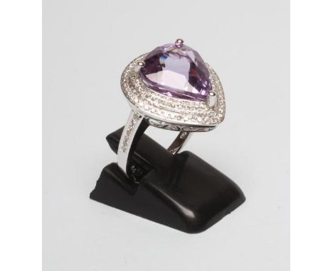 AN AMETHYST AND DIAMOND DRESS RING, the pear cut amethyst of approximately 6.33cts collet set to a double border of pave set 