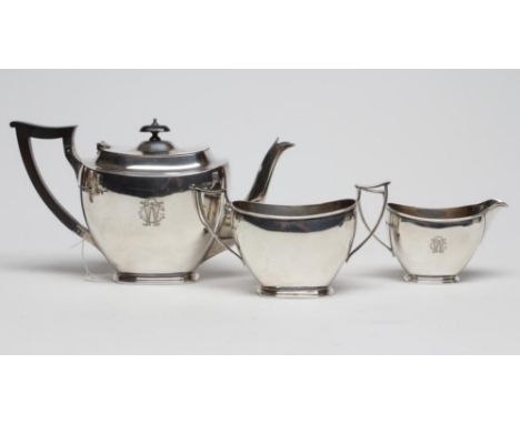 A SILVER THREE PIECE TEA SERVICE, maker J. Dixon, Sheffield 1935, of plain rounded oblong form engraved with a monogram, comp