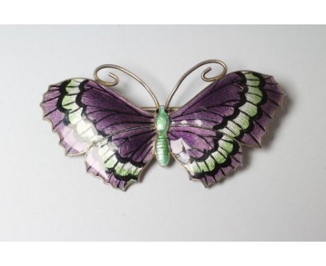 A STERLING SILVER AND ENAMEL BUTTERFLY BROOCH with green and black markings to dark lilac wings and green thorax, stamped JA 