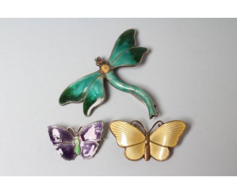 A STERLING SILVER AND ENAMEL DRAGONFLY BROOCH with green wings and tail and yellow thorax, 1 3/4" wide, together with a Norwe