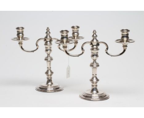 A PAIR OF SILVER 18TH CENTURY STYLE SMALL CANDELABRA, maker's mark R.C.(William Comyns), London 1962, the bobbin cast fixed s