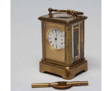 A MINIATURE BRASS CASED CARRIAGE CLOCK, the single barrel movement with platform escapement, the white enamel dial with Roman