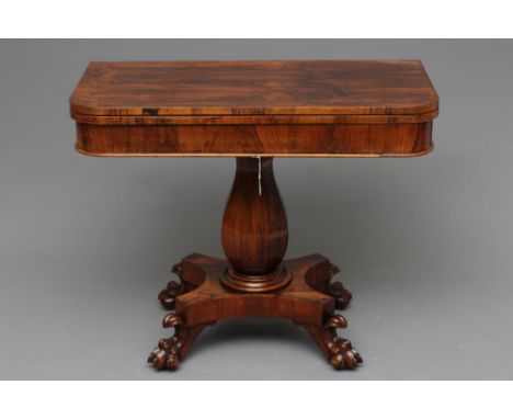 A VICTORIAN ROSEWOOD FOLDING TEA TABLE of rounded oblong form with swivel top, faceted baluster stem with turned collar, on c