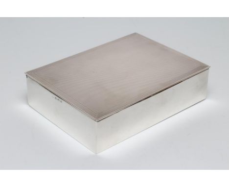 AN ART DECO SILVER CIGARETTE BOX, maker Alfred Deeley, Birmingham 1941, of plain oblong form, the hinged flat cover with engi