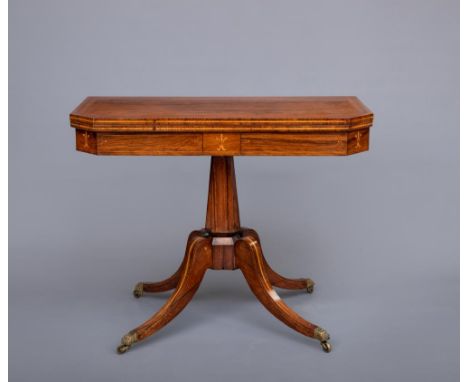 A REGENCY ROSEWOOD FOLDING CARD TABLE, early 19th century, of canted oblong form with stringing, dentil inlaid and banded swi