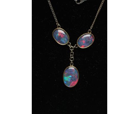 AN OPAL NECKLACE, modern, the three collet set oval cabochon polished opals with black glass(?) backs on an 18ct white gold c