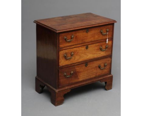 A SMALL MAHOGANY STRAIGHT FRONTED CHEST, the moulded edged top over three drawers with brass drop handles, moulded base and b