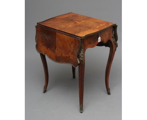 A FRENCH KINGWOOD AND MARQUETRY LOUIS XVI STYLE TABLE, late 19th century, of oblong serpentine drop leaf form with gilt metal