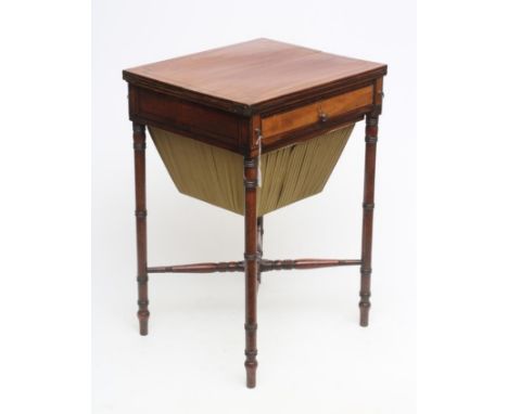 A REGENCY MAHOGANY SEWING TABLE, early 19th century, of oblong form with ebony stringing, split hinged top on lopers, frieze 