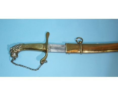 A British military band sword, the plain brass hilt with lion pommel and chainlet, the 78cm single fullered curved blade in b