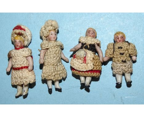 Four Carl Horn miniature bisque dolls with crocheted clothes, 3cm, 3.5cm and 4cm (x2). 