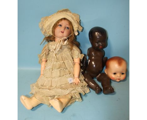 A bisque-head Handwerk doll on wood and composition jointed body, marked HW Germany, 6½, an unmarked composition doll and a P