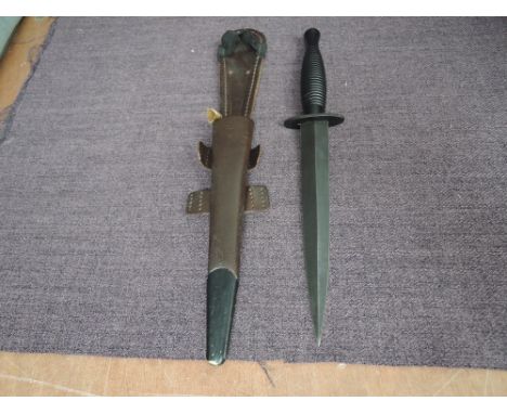 A Fairburn Sykes 3rd Pattern Commando Knife with leather and metal scabbard, blade length 18cm overall length 30cm, in good c