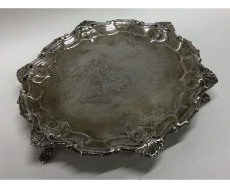A crested Georgian style silver salver. Sheffield 1919. By William Hutton and Sons Ltd. Approx. 193 grams. Est. £160 - £200.