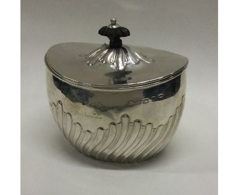 A silver fluted tea caddy with hinged lid. Birmingham. Approx. 115 grams. Est. £80 - £120.