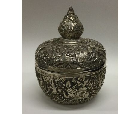 An unusual Thai silver tea caddy chased with elephants and carriages to lift-off lid. Approx. 491 grams. Est. £350 - £400.