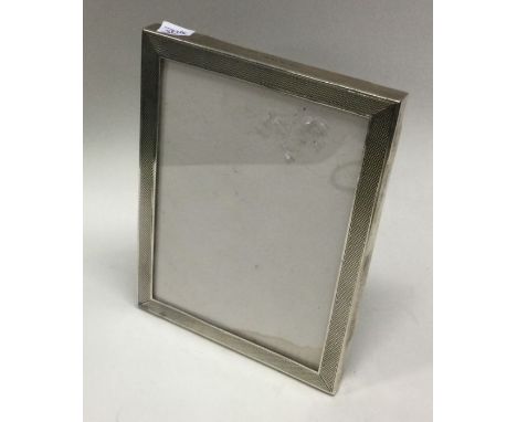 A silver mounted glass engine turned silver frame. Birmingham 1921. By S&amp;M. Est. £50 - £80.