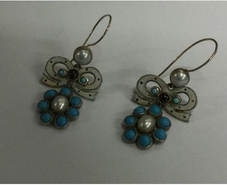 A pair of stylish turquoise and enamel earrings with loop tops. Approx. 6 grams. Est. £150 - £200.