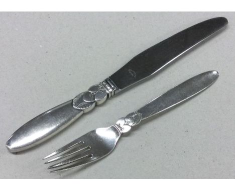 GEORG JENSEN: A heavy silver knife and fork of typical form. Approx. 149 grams. Est. £100 - £150.