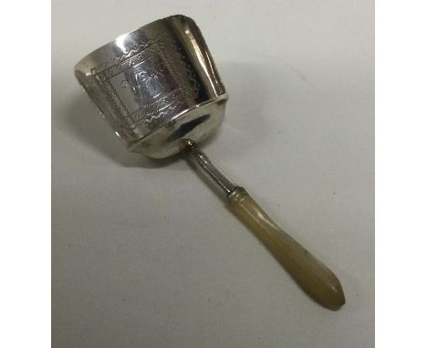 A George III bright cut silver and MOP caddy spoon. Birmingham 1807. By Joseph Taylor. Approx. 9 grams. Est. £50 - £80.