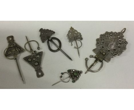 A group of five Eastern silver cloak pins. Approx. 89 grams. Est. £30 - £50.