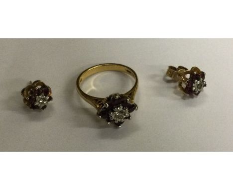 A ruby and diamond circular cluster ring in 18 carat gold together with matching earrings. Approx. 5 grams. Est. £50 - £80.