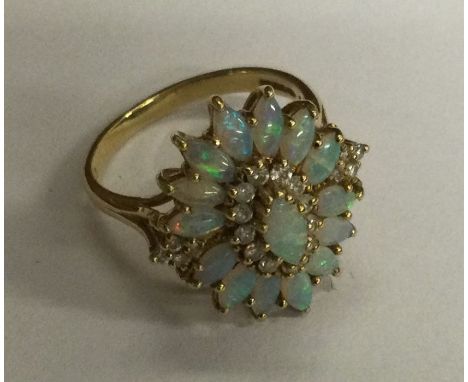 A good quality opal and diamond cluster ring in 18 carat gold claw setting. Approx. 7 grams. Est. £100 - £150.